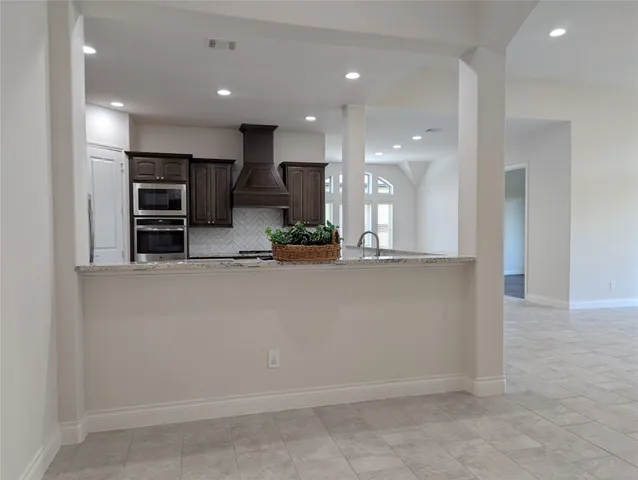a spacious bathroom with a tub sink and mirror