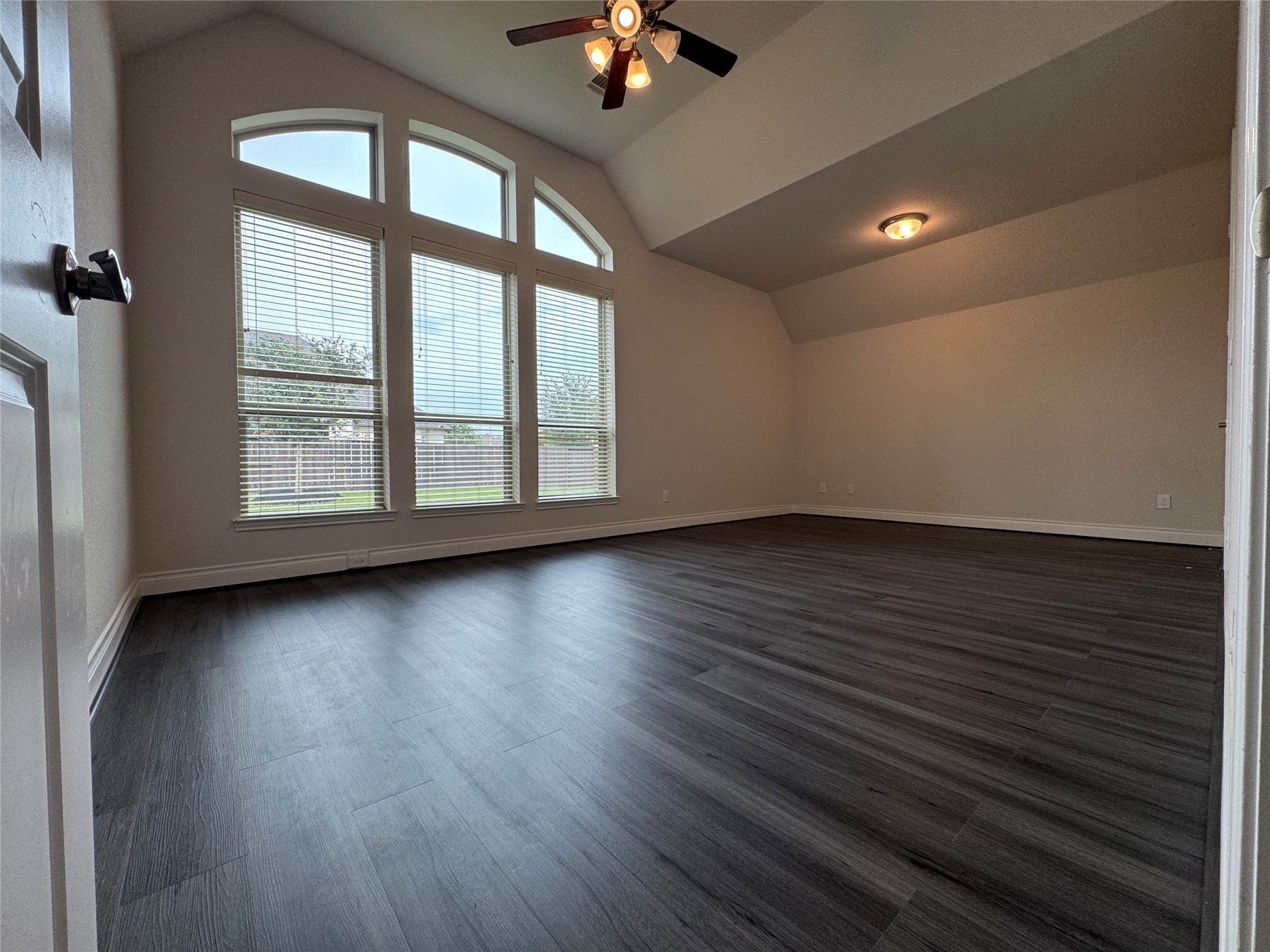 10323 Granite Court Rosharon, TX 77583 - Photo 14 of 44 an empty room with wooden floor chandelier fan and windows