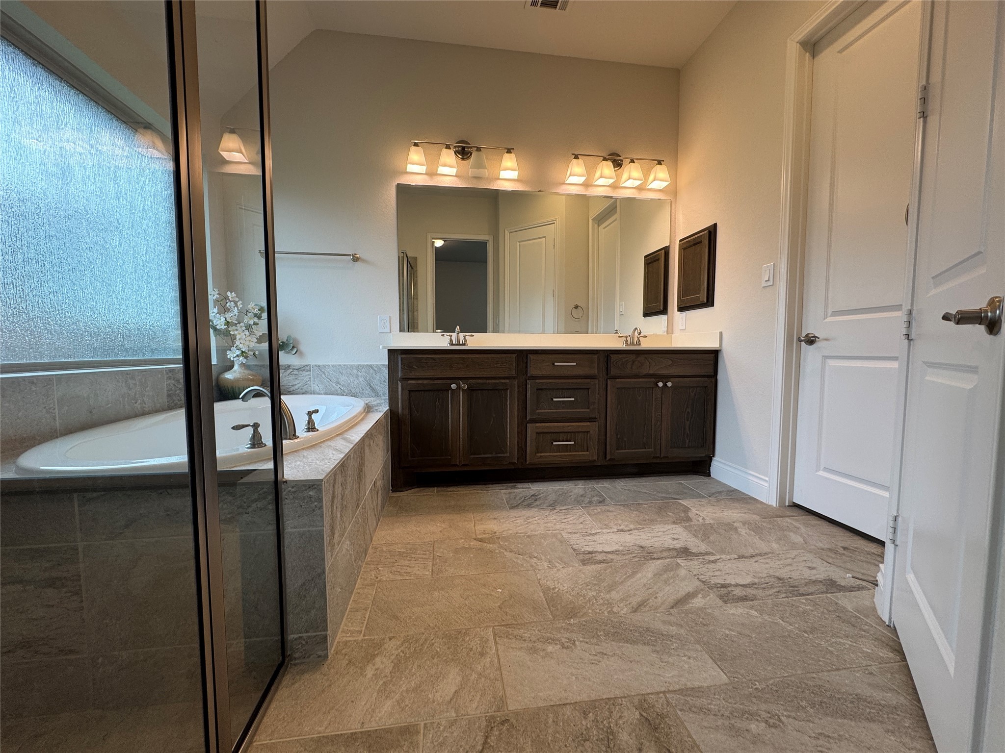 10323 Granite Court Rosharon, TX 77583 - Photo 16 of 44 a spacious bathroom with a tub sink and mirror