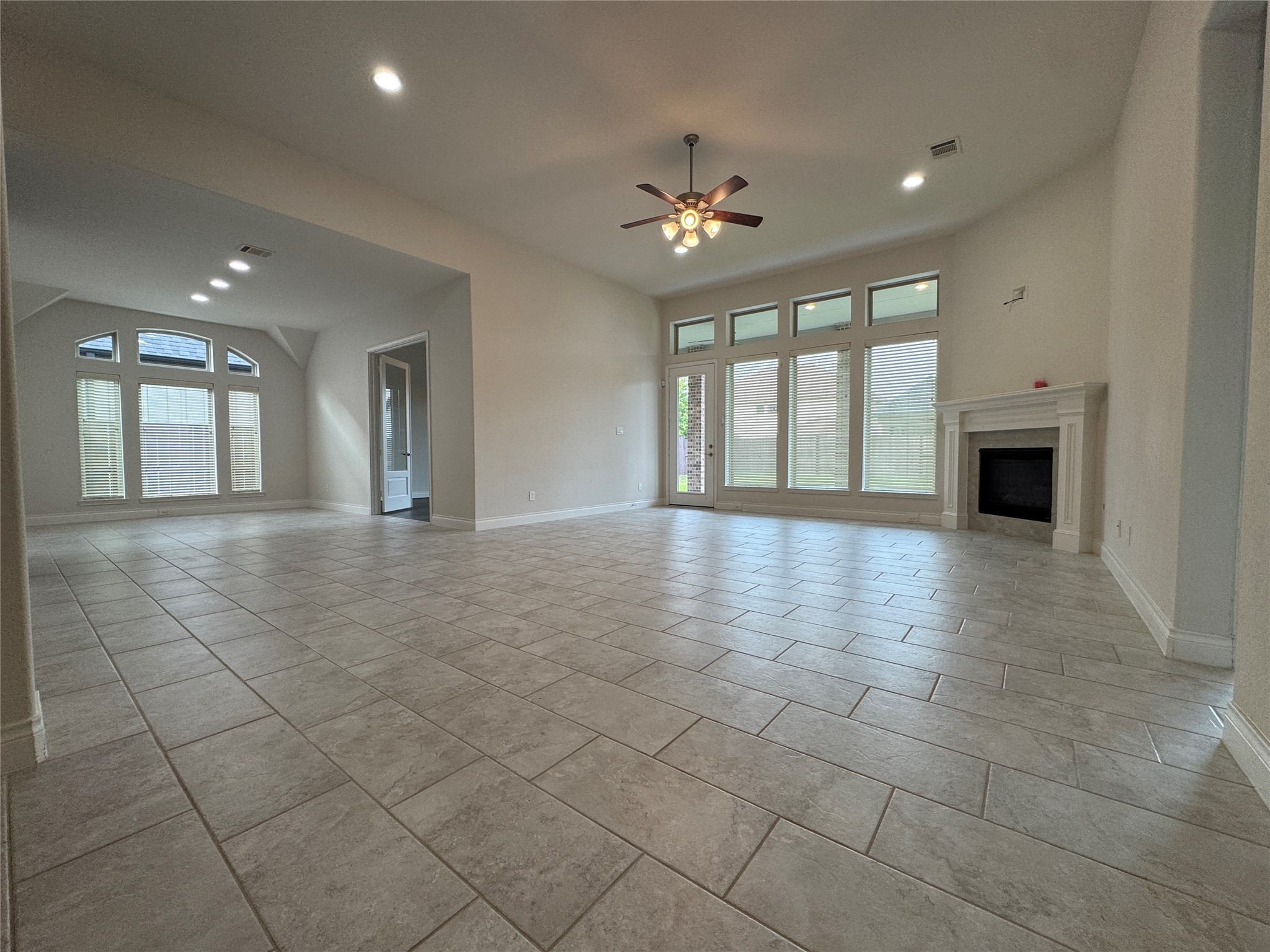 10323 Granite Court Rosharon, TX 77583 - Photo 19 of 44 a view of an empty room with a fireplace and a window