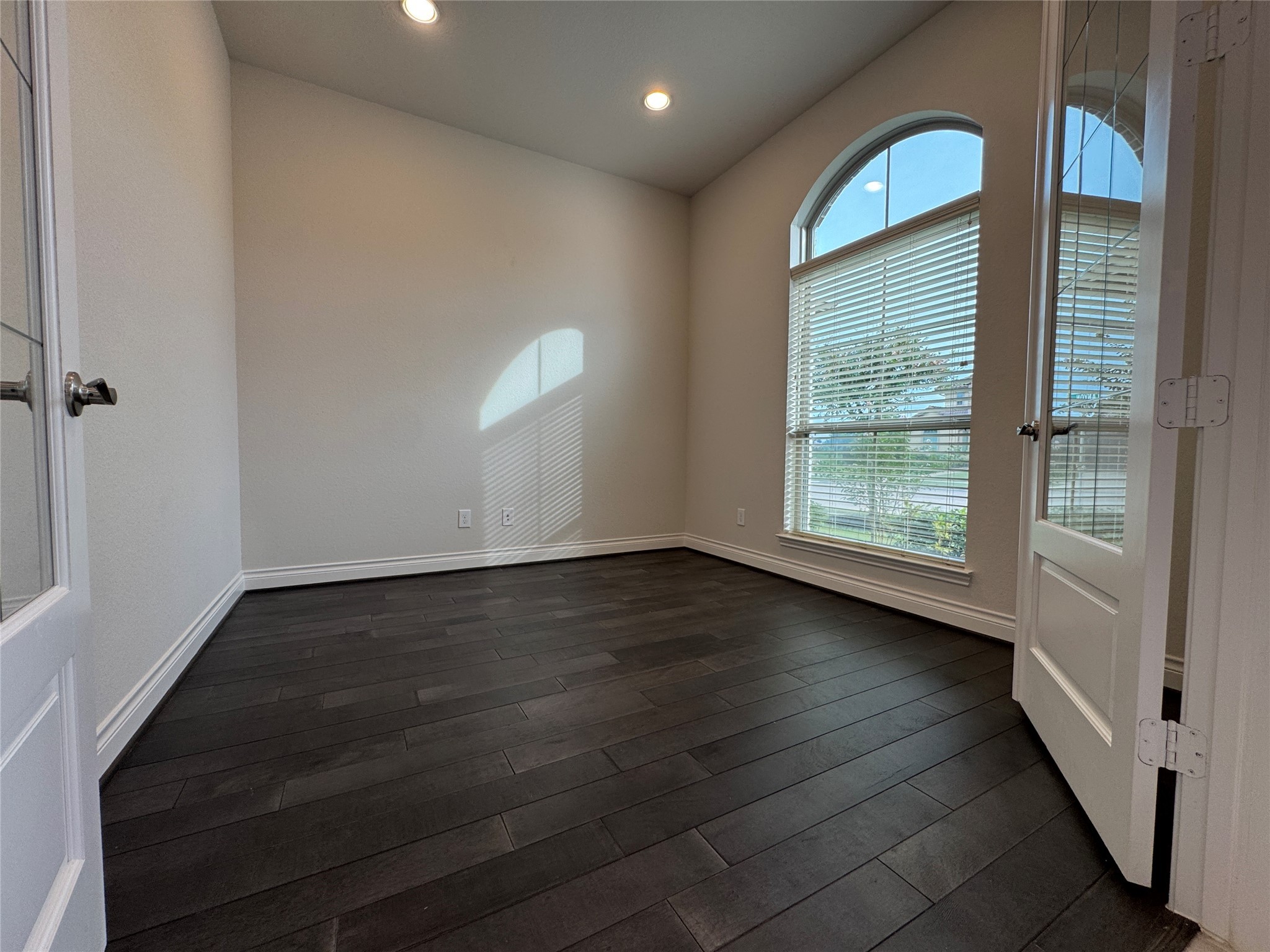 10323 Granite Court Rosharon, TX 77583 - Photo 2 of 44 an empty room with wooden floor and windows