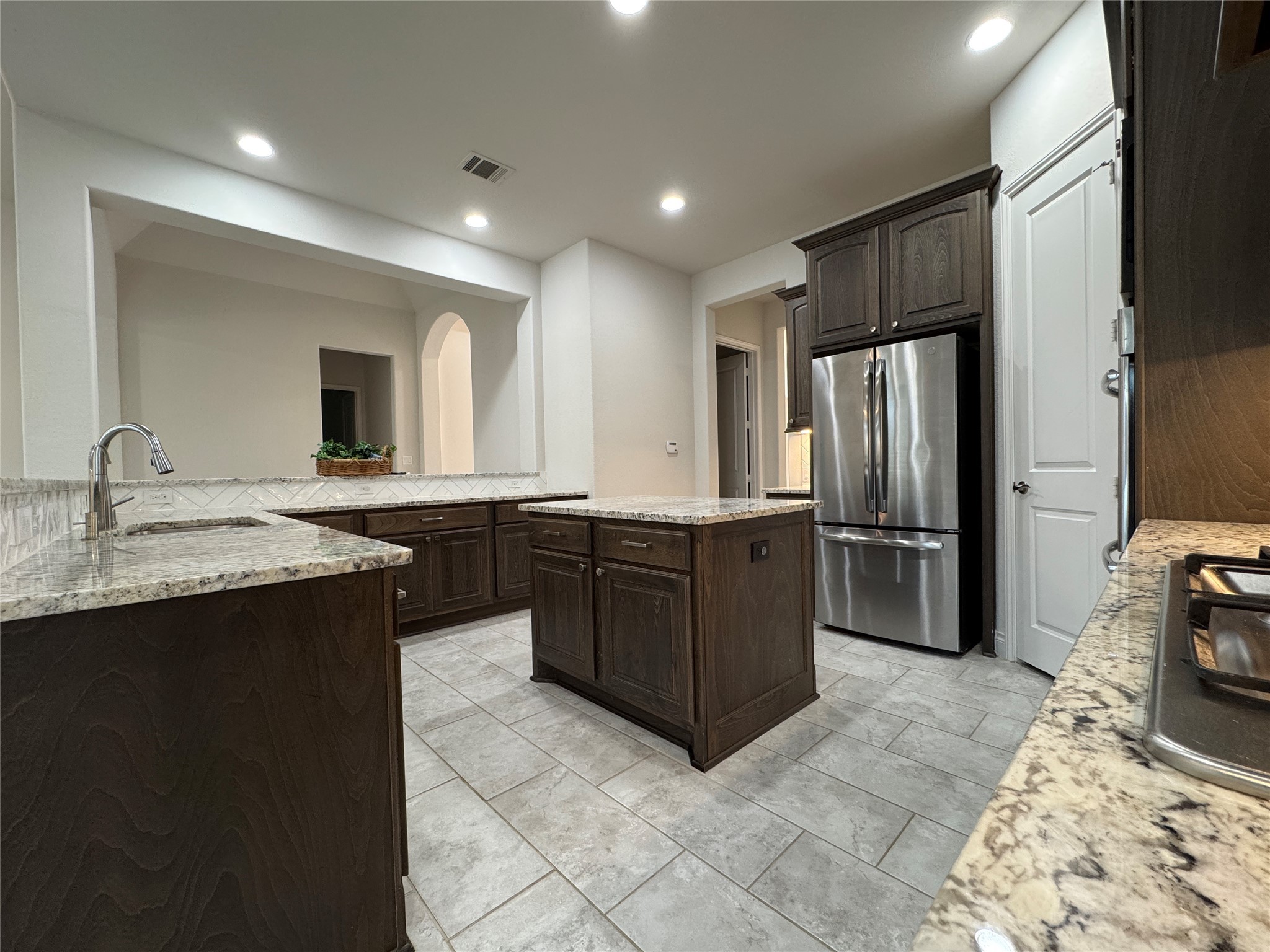 10323 Granite Court Rosharon, TX 77583 - Photo 25 of 44 a kitchen with a sink refrigerator and cabinets