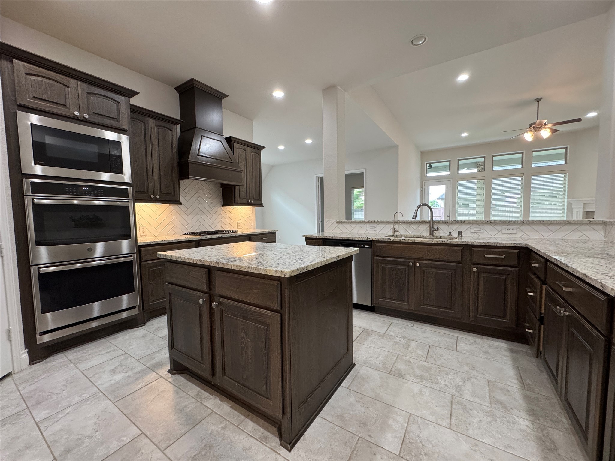 10323 Granite Court Rosharon, TX 77583 - Photo 26 of 44 a kitchen with a sink stove and microwave