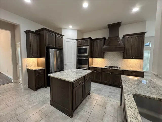 a view of a swimming pool with a yard and a wooden fence