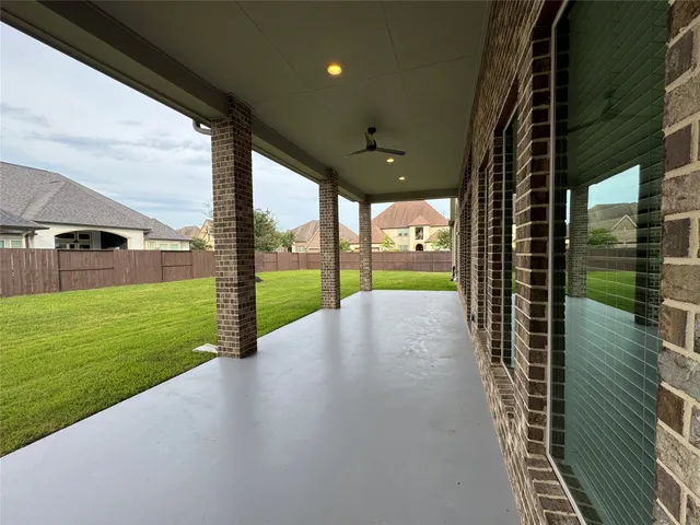 a swimming pool with outdoor seating and yard