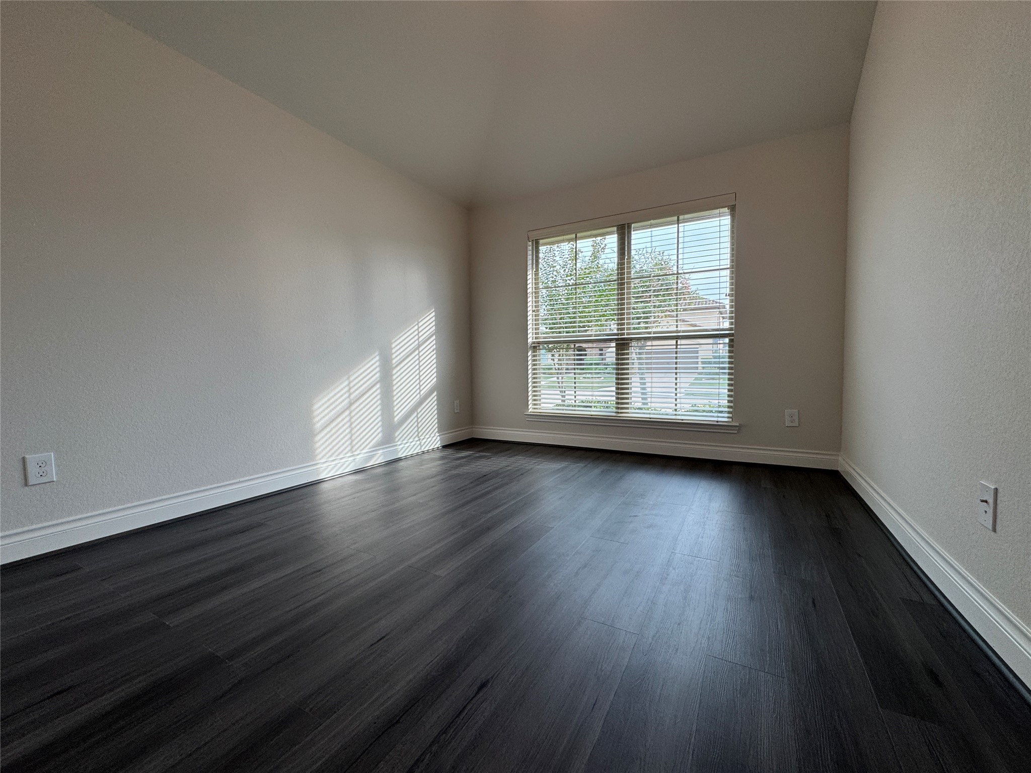 10323 Granite Court Rosharon, TX 77583 - Photo 4 of 44 an empty room with wooden floor and windows