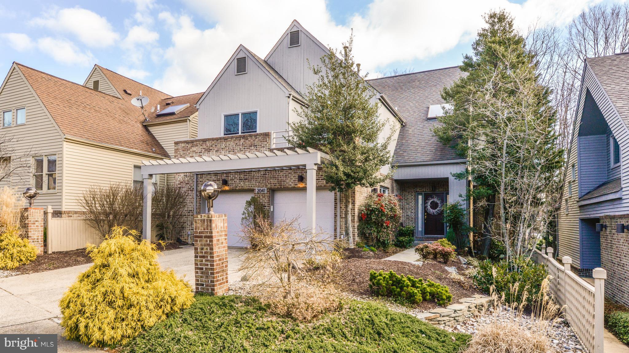 2041 Beacon Place Reston, VA 20191 - Photo 1 of 30 a front view of a house with garden