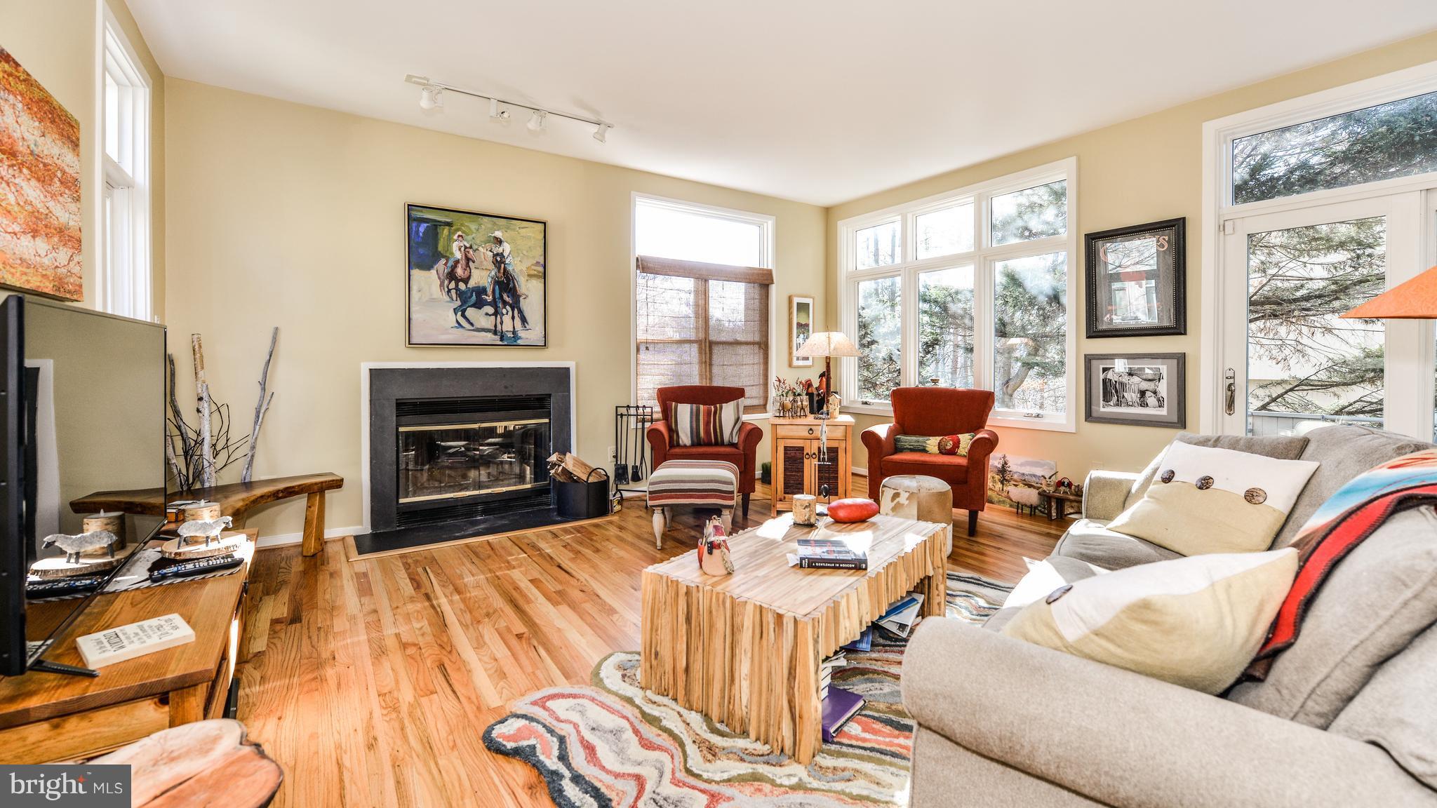 2041 Beacon Place Reston, VA 20191 - Photo 11 of 30 a living room with furniture large window and a flat screen tv