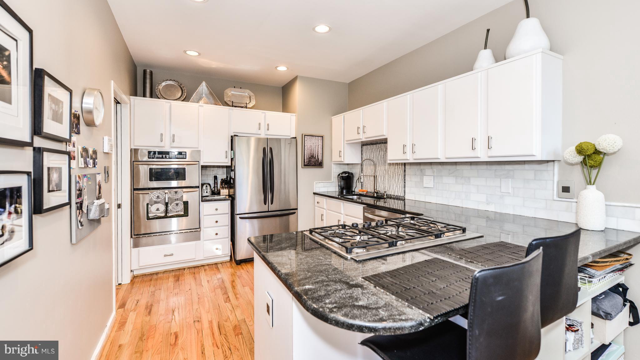 2041 Beacon Place Reston, VA 20191 - Photo 5 of 30 a kitchen with stainless steel appliances granite countertop a sink stove and refrigerator