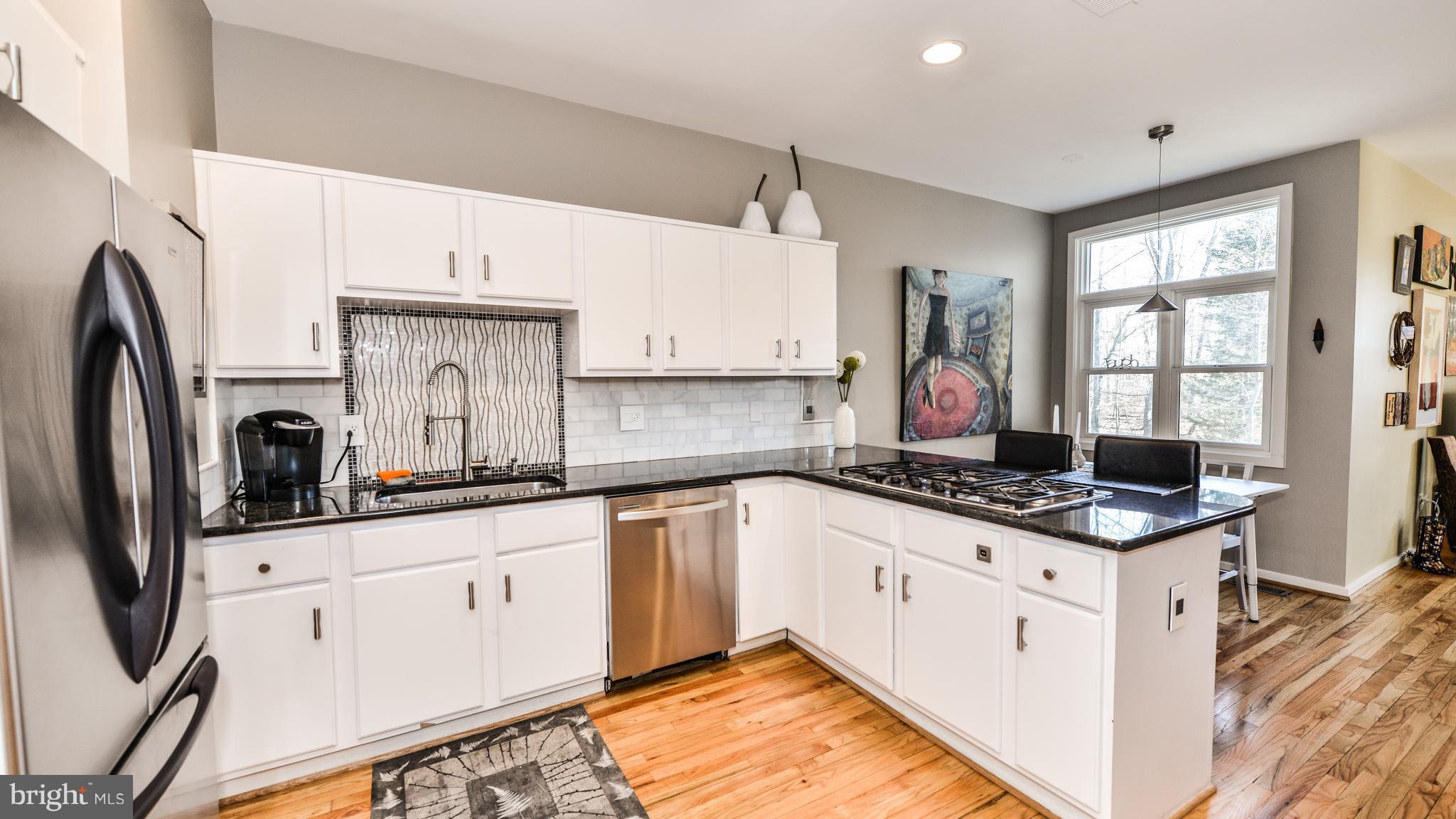 2041 Beacon Place Reston, VA 20191 - Photo 6 of 30 a kitchen with granite countertop a sink stove and cabinets