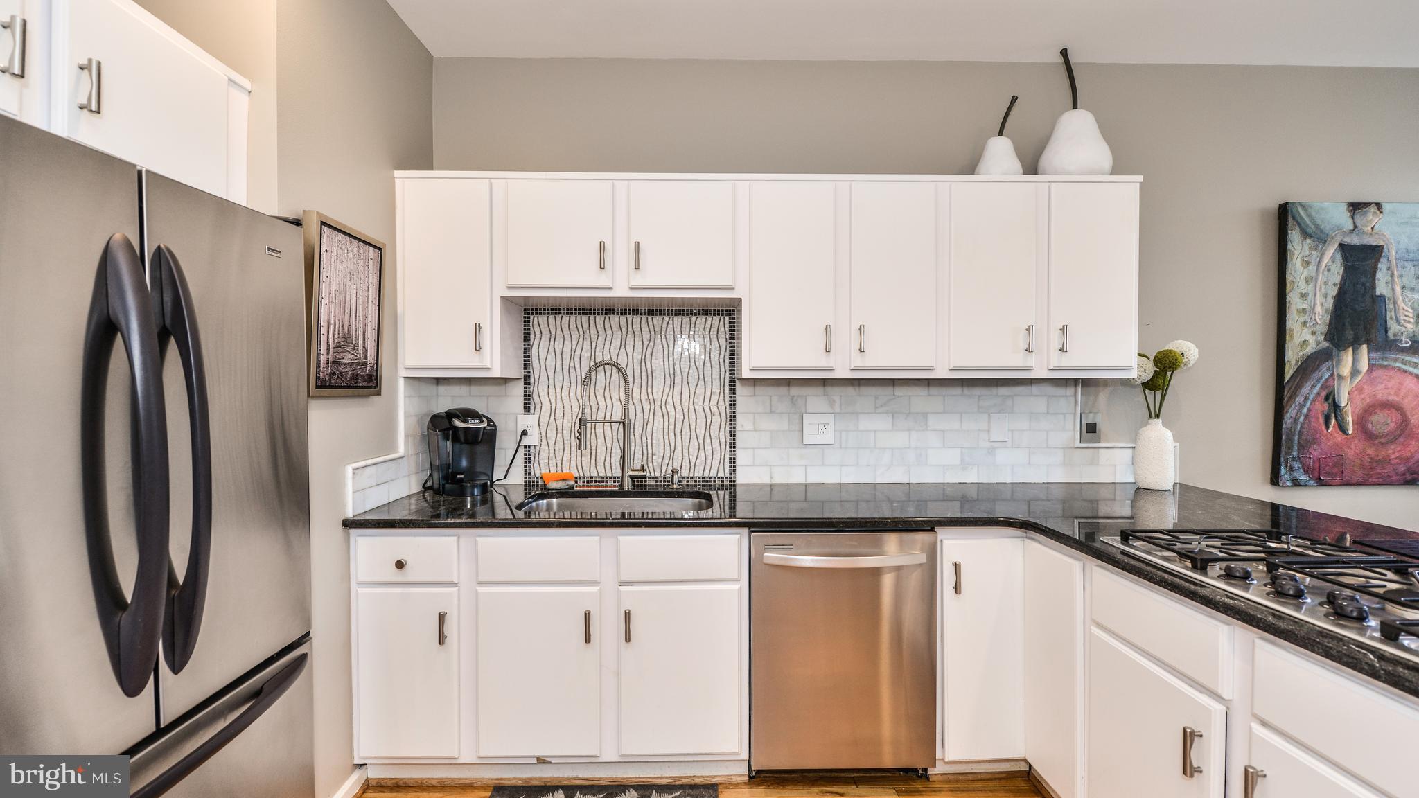 2041 Beacon Place Reston, VA 20191 - Photo 7 of 30 a kitchen with stainless steel appliances granite countertop a refrigerator sink and cabinets
