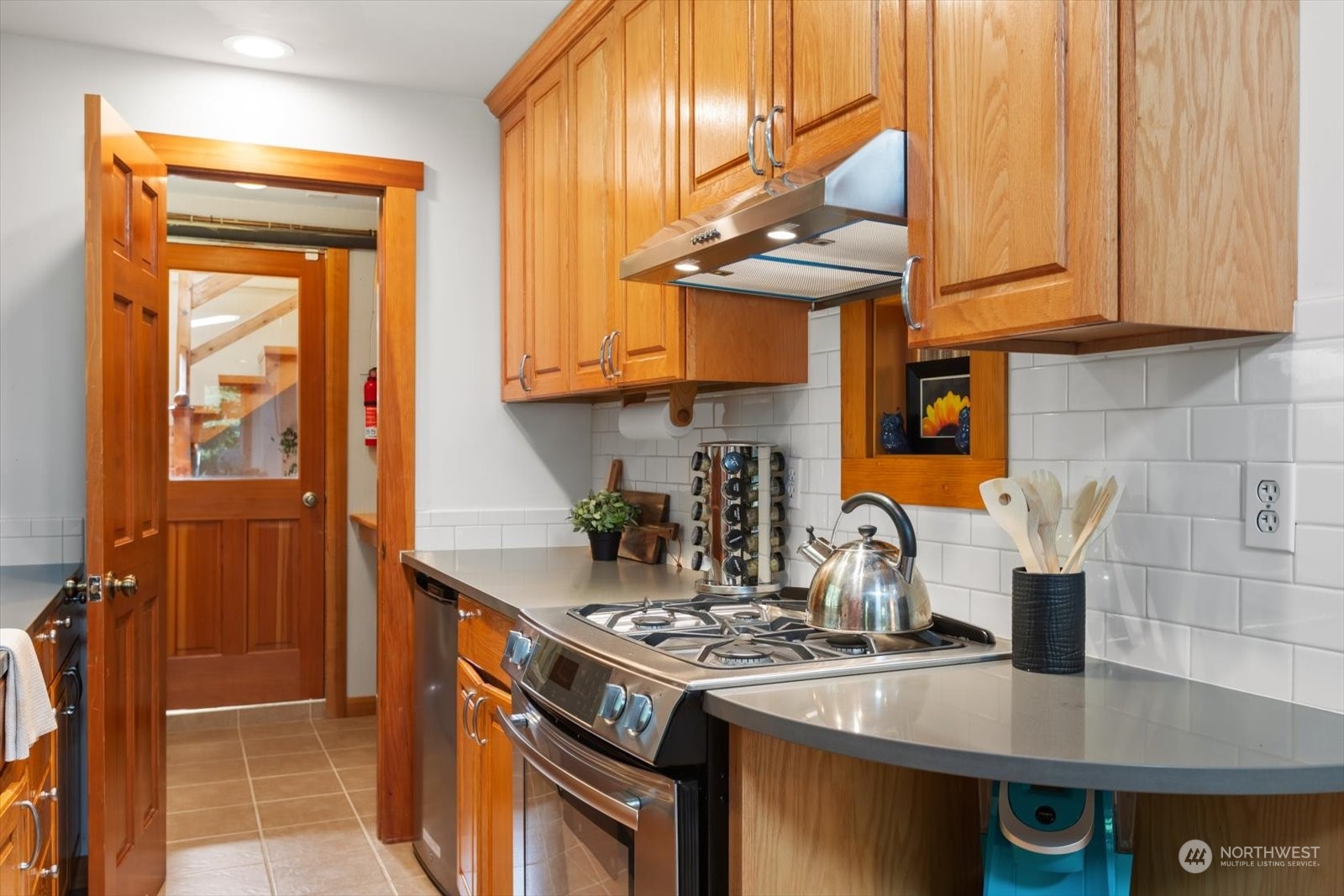 15908 68th Avenue West Edmonds, WA 98026 - Photo 28 of 40 a kitchen with stainless steel appliances granite countertop a stove a sink and a microwave