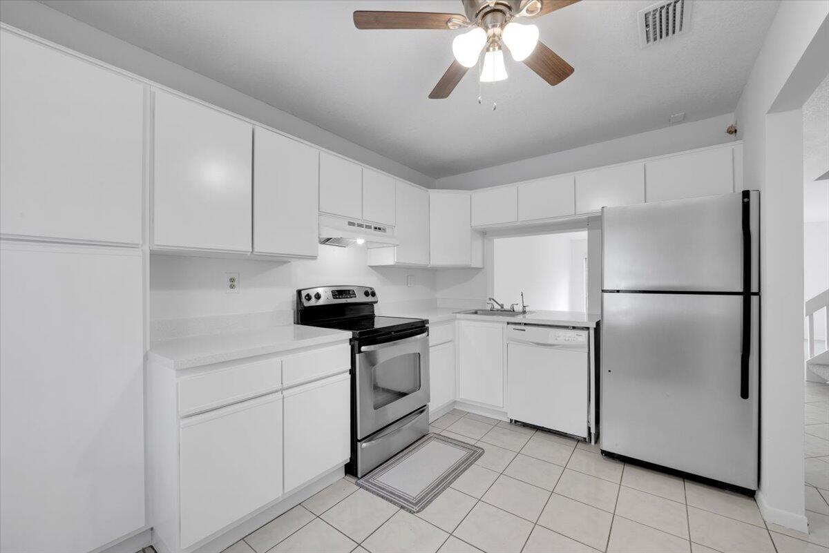 4718 Northwest 82nd Avenue, Unit 1706 Lauderhill, FL 33351 - Photo 2 of 12 a kitchen with cabinets stainless steel appliances and a chandelier