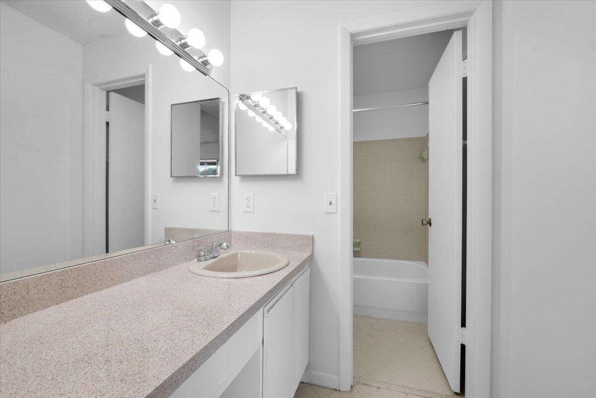 4718 Northwest 82nd Avenue, Unit 1706 Lauderhill, FL 33351 - Photo 6 of 12 a bathroom with a sink and a mirror
