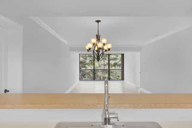 a view of a kitchen with a sink and chandelier