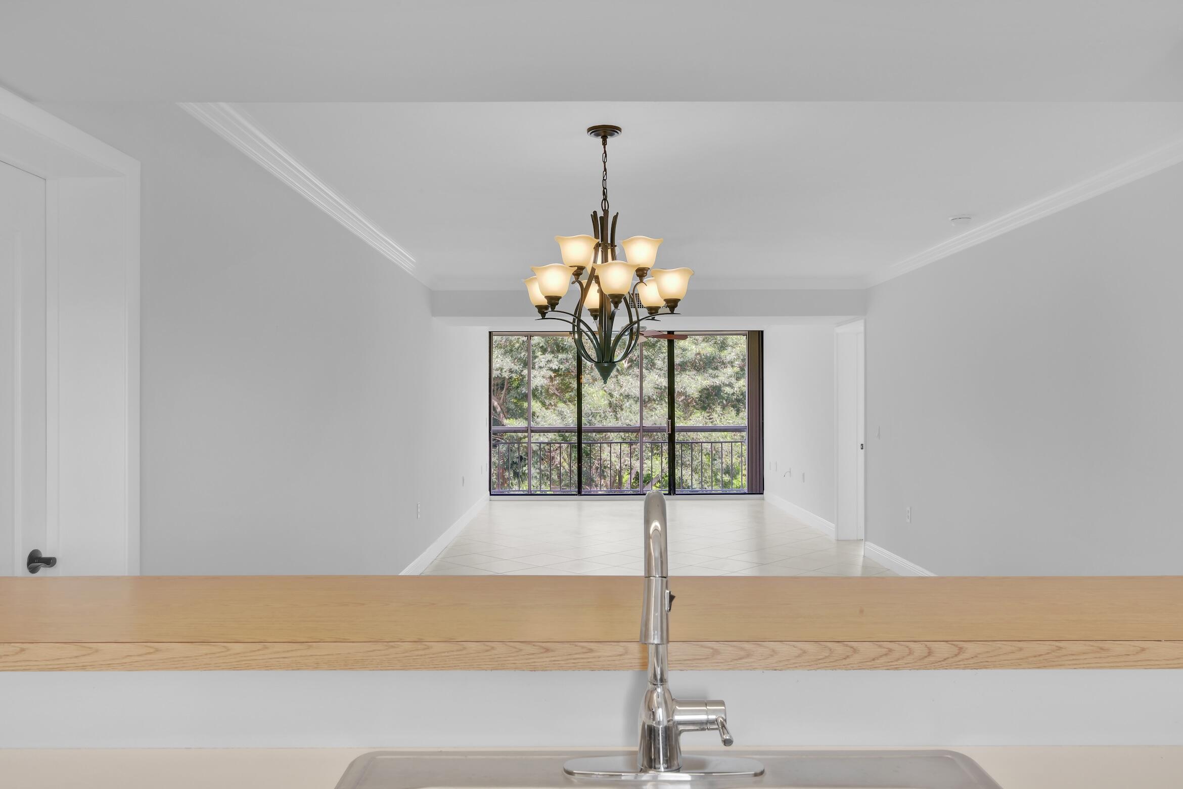 6133 Balboa Circle, Unit 304 Boca Raton, FL 33433 - Photo 15 of 48 a view of a kitchen with a sink and chandelier