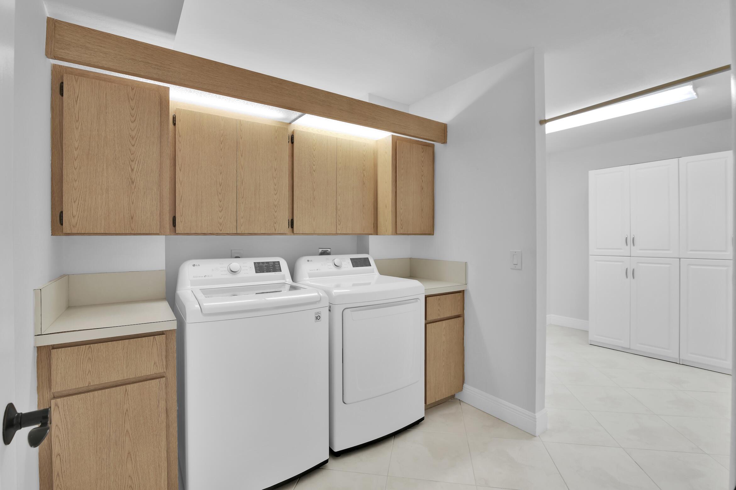 6133 Balboa Circle, Unit 304 Boca Raton, FL 33433 - Photo 19 of 48 a utility room with dryer and washer