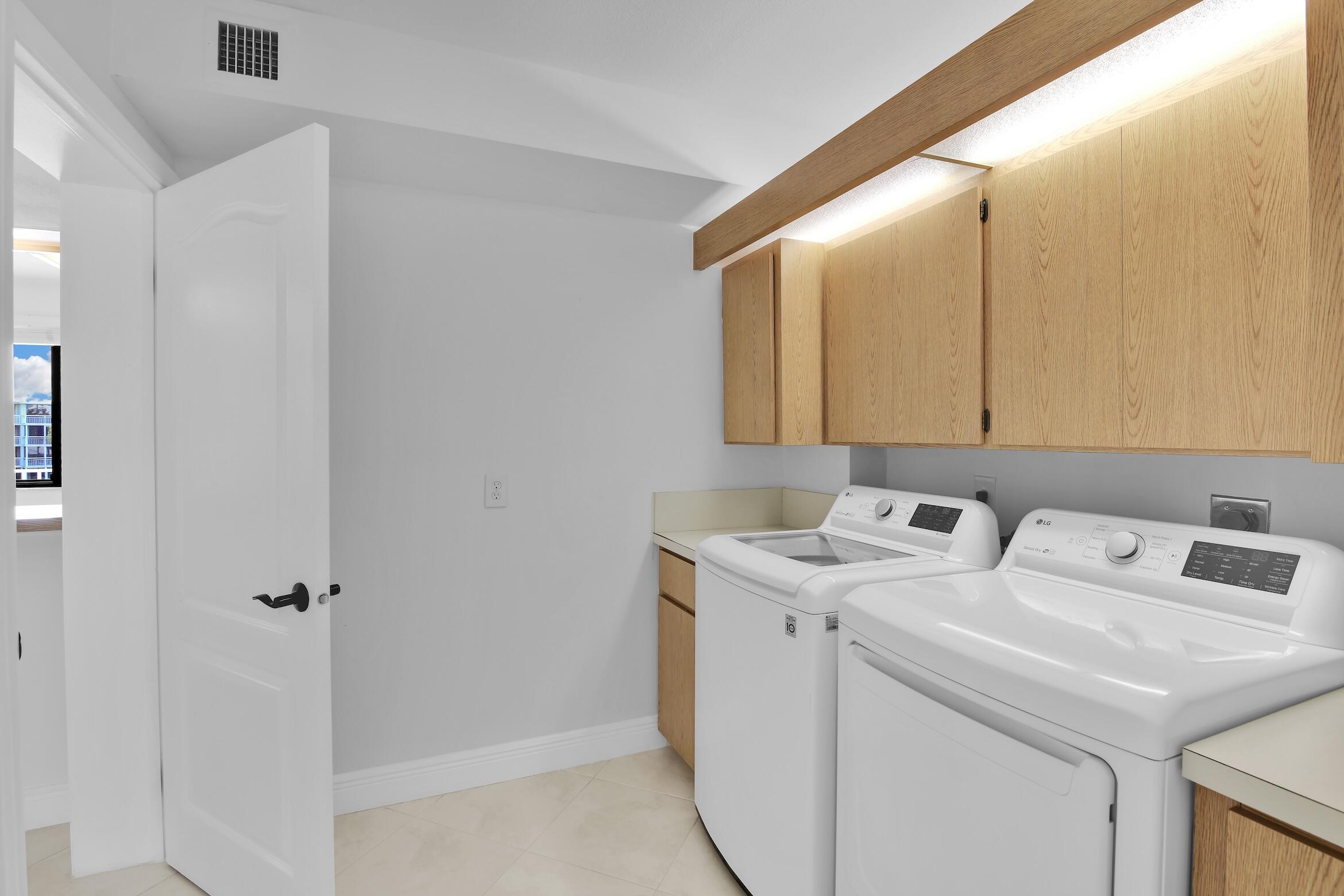 6133 Balboa Circle, Unit 304 Boca Raton, FL 33433 - Photo 22 of 48 a utility room with dryer and washer