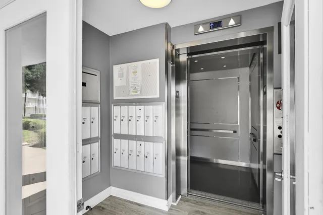 a bathroom with a glass shower door and a mirror