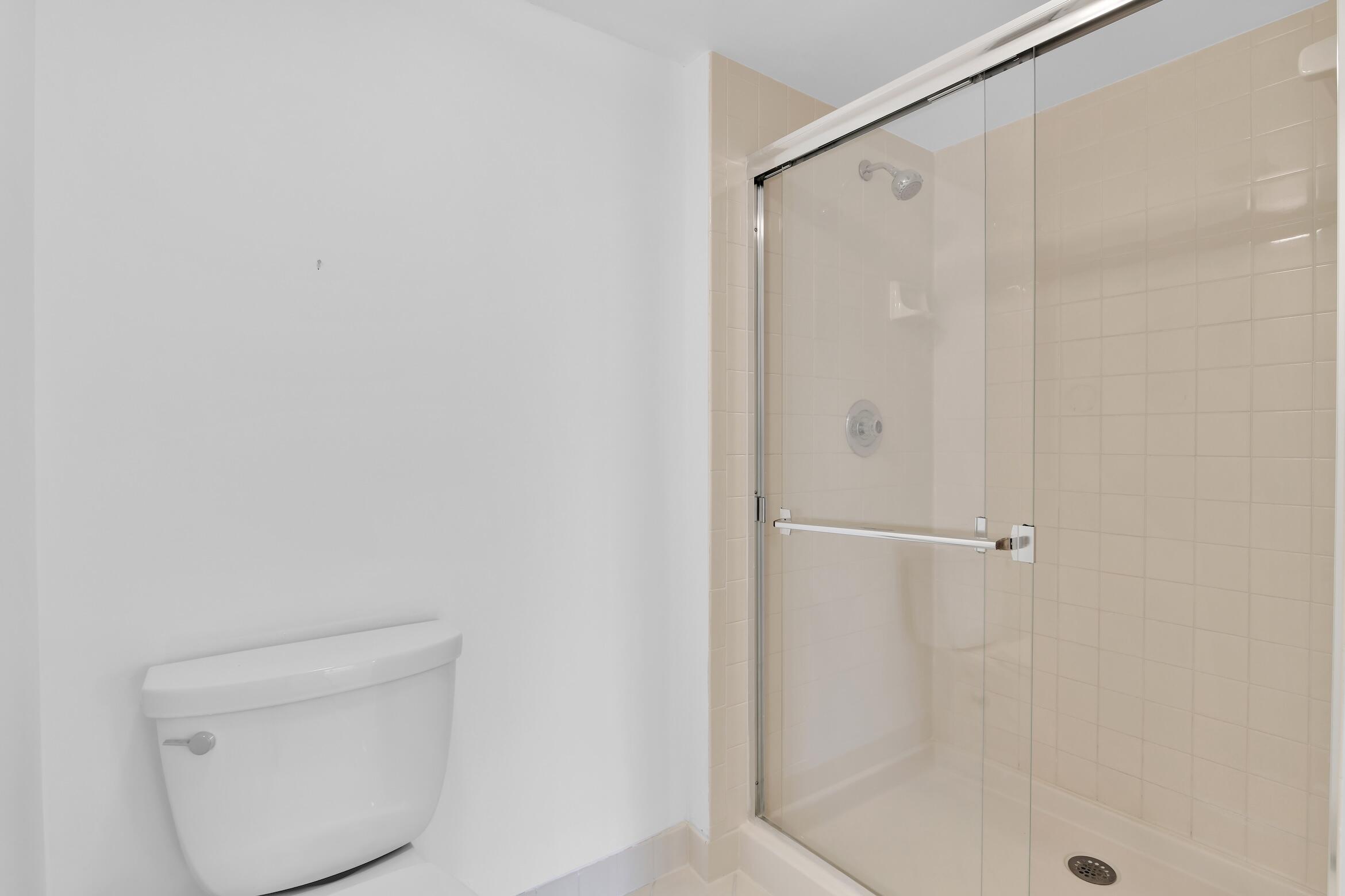 6133 Balboa Circle, Unit 304 Boca Raton, FL 33433 - Photo 37 of 48 a bathroom with a shower and a toilet