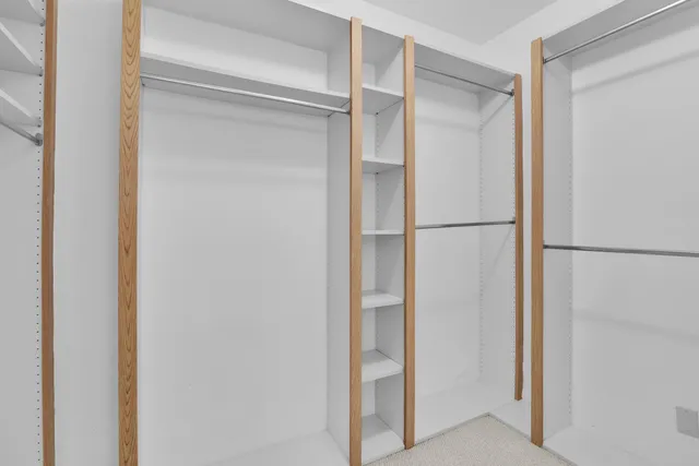 a bathroom with a double vanity sink toilet mirror and shower