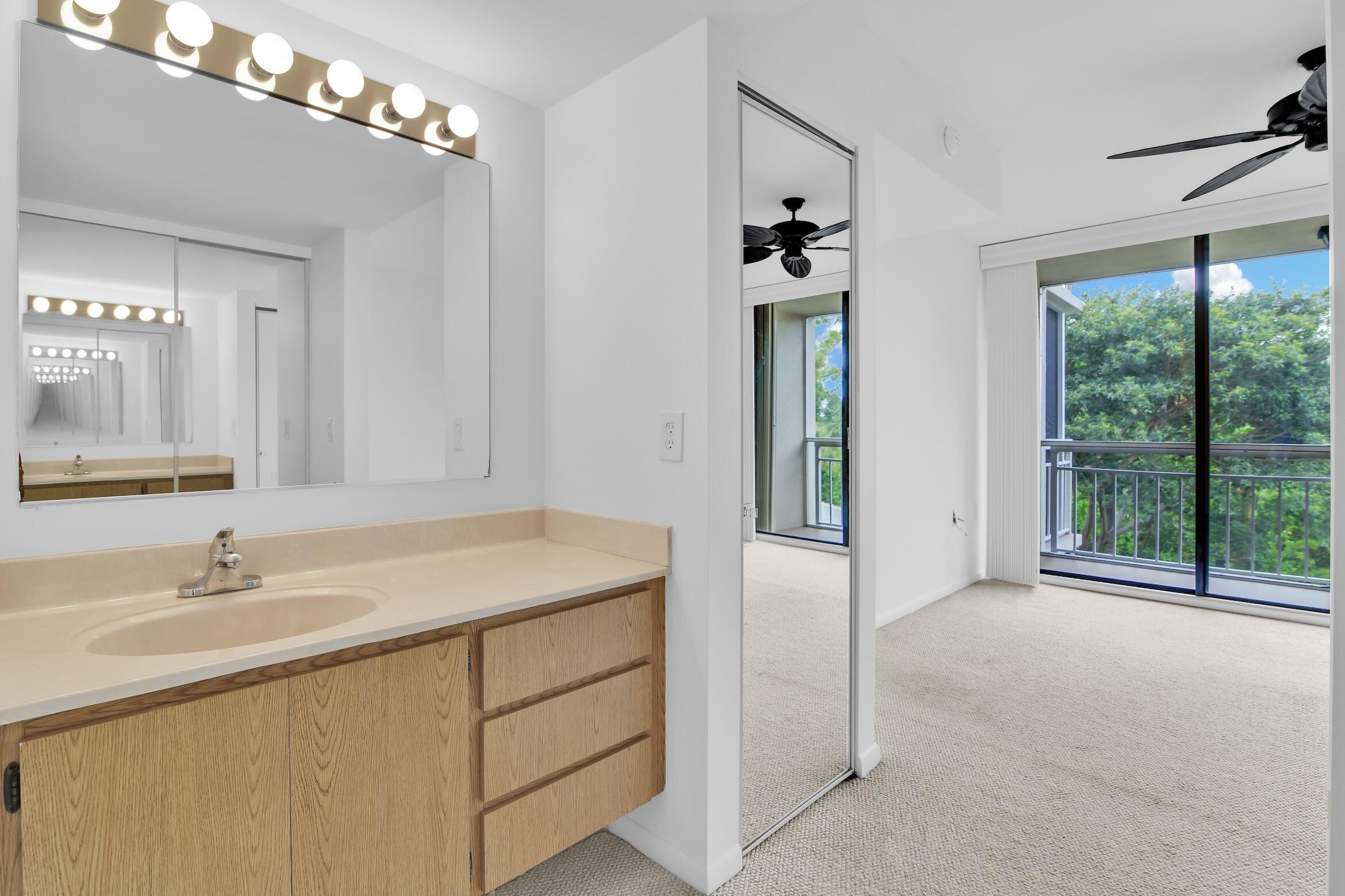 6133 Balboa Circle, Unit 304 Boca Raton, FL 33433 - Photo 39 of 48 a bathroom with a sink vanity and a mirror