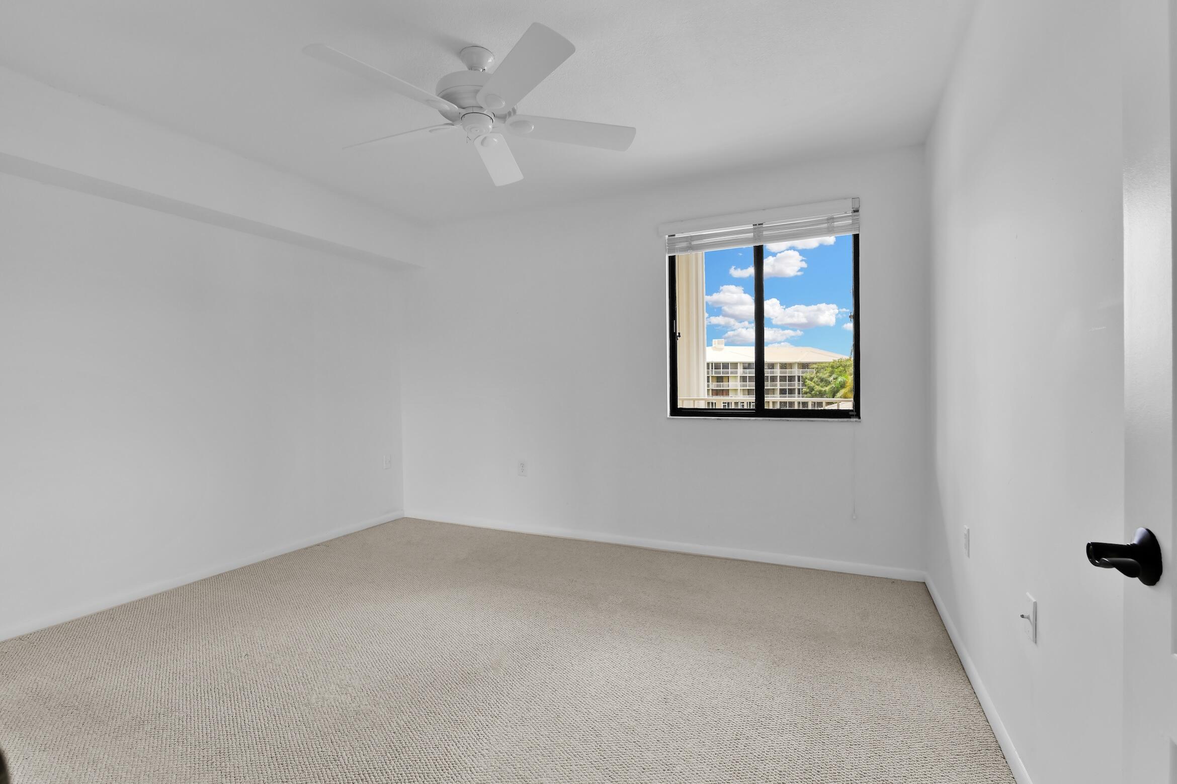 6133 Balboa Circle, Unit 304 Boca Raton, FL 33433 - Photo 41 of 48 an empty room with a window and a fan