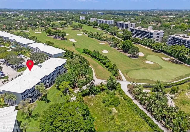a view of a house with a yard and lake view