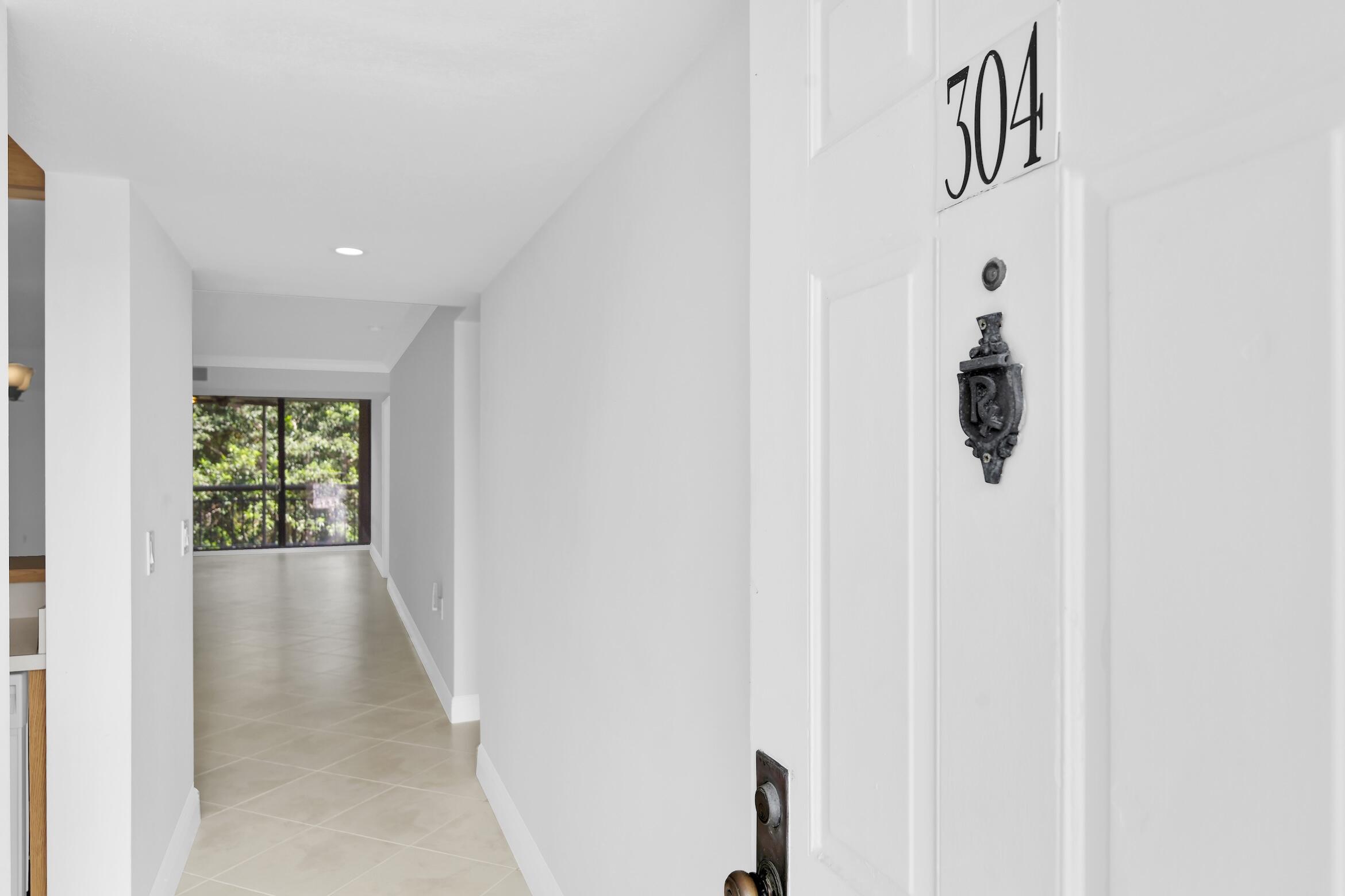 6133 Balboa Circle, Unit 304 Boca Raton, FL 33433 - Photo 7 of 48 a view of hallway with window
