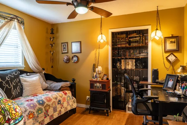 a bedroom with a bed and wooden floor