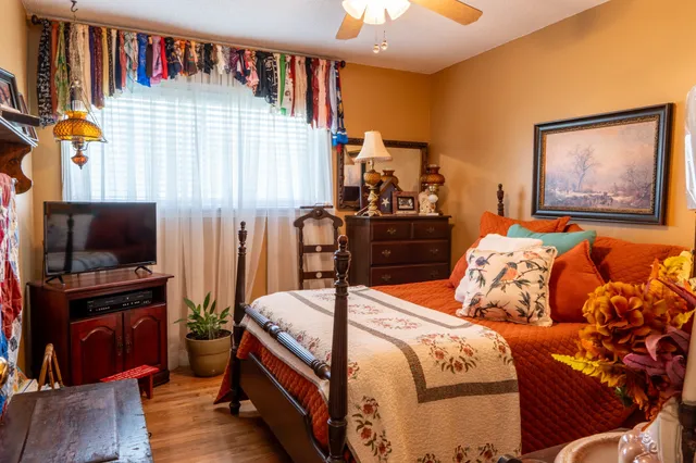 a bedroom with furniture and a flat screen tv