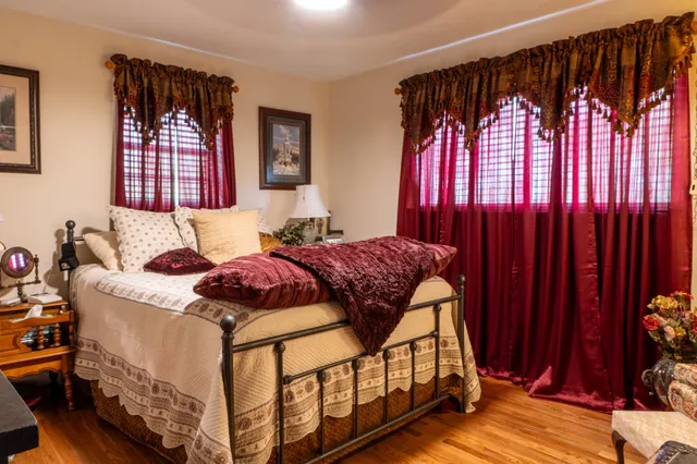 a bedroom with a bed and a window