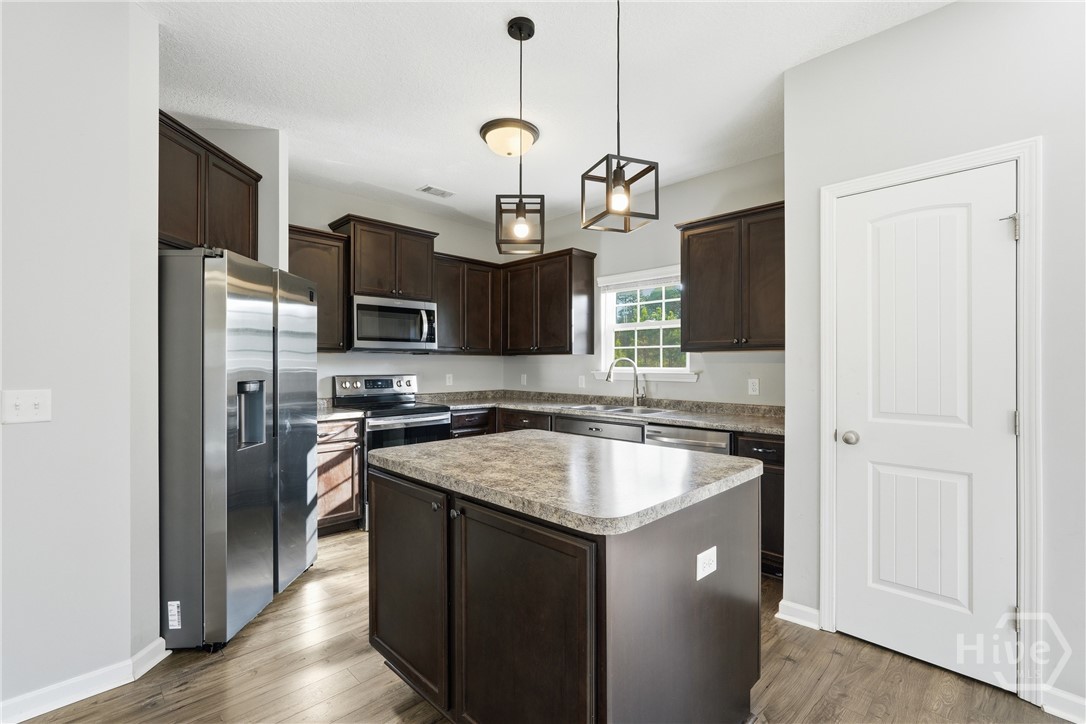 1297 Talmadge Road Allenhurst, GA 31301 - Photo 9 of 32 Kitchen with island and pendants