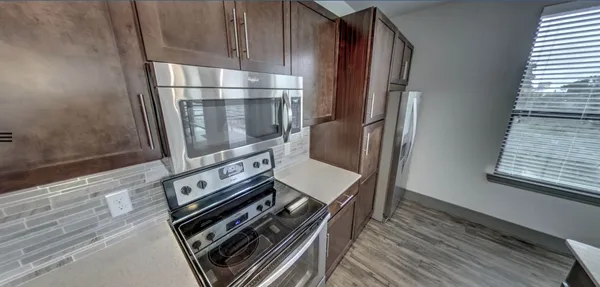 a kitchen with wooden cabinets and a stove
