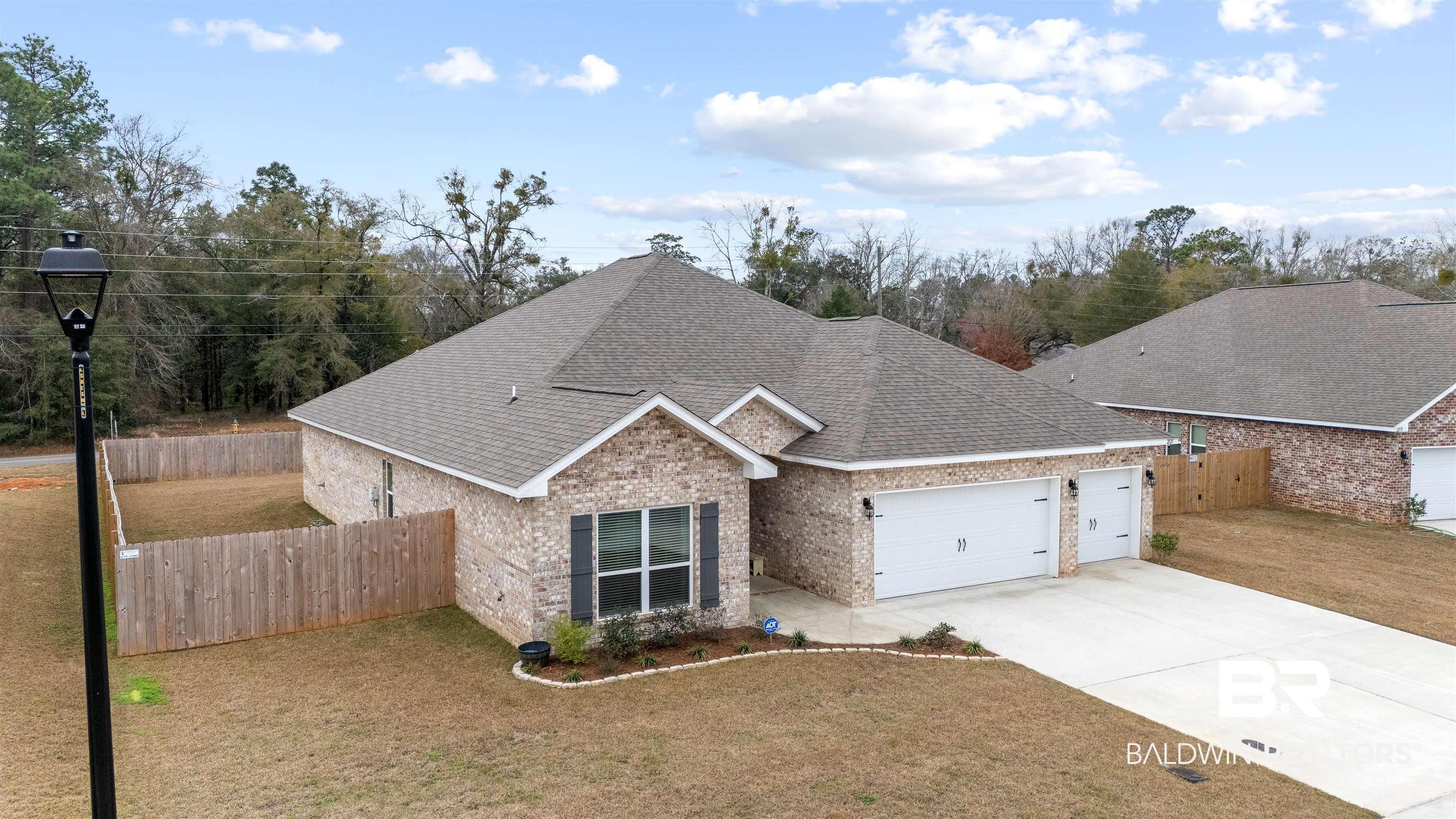 2121 Meadowview Loop Semmes, AL 36575 - Photo 3 of 46 View of front of home featuring a garage and a front lawn