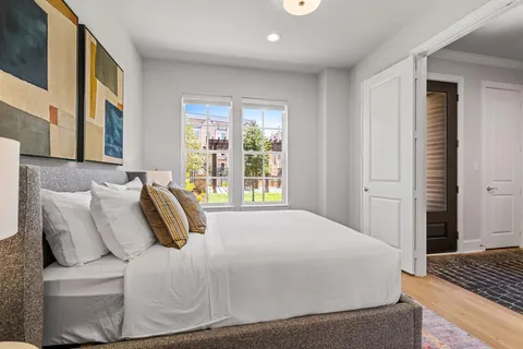 a bedroom with a bed and wooden floor