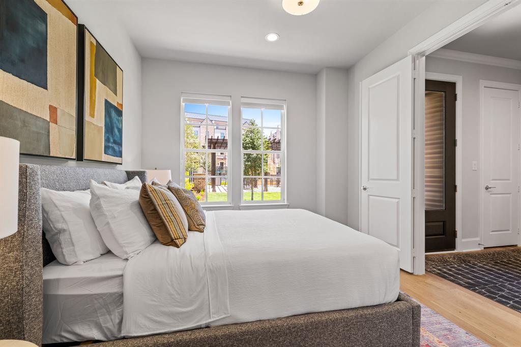 5449 Patterson Court Irving, TX 75039 - Photo 14 of 18 a bedroom with a bed and wooden floor