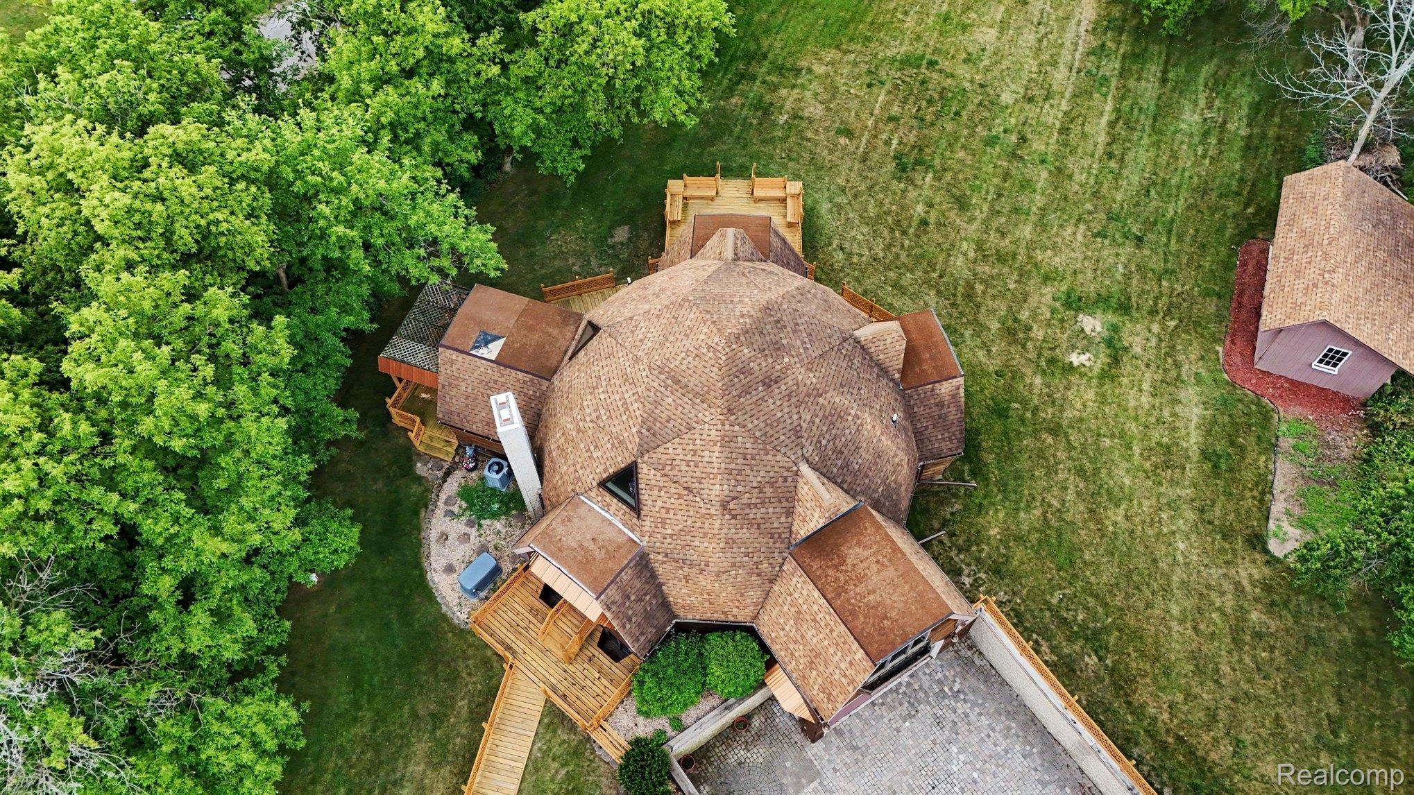 4425 North Henderson Road Davison, MI 48423 - Photo 41 of 43 Unique geodesic dome residence featuring a shingle roof and multiple exterior decks