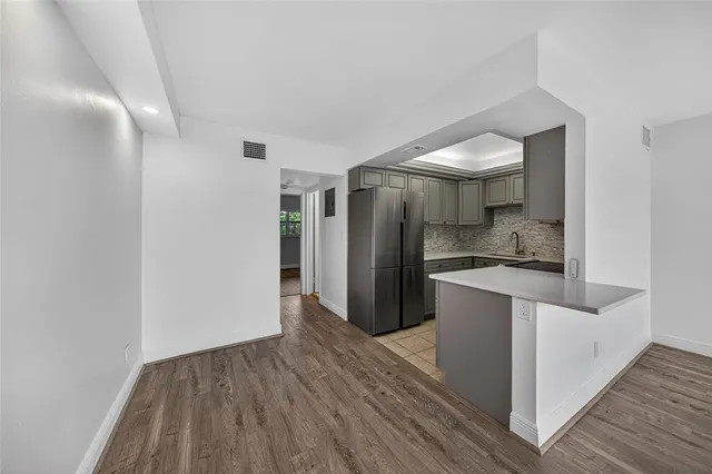 a kitchen with stainless steel appliances granite countertop a refrigerator and a sink