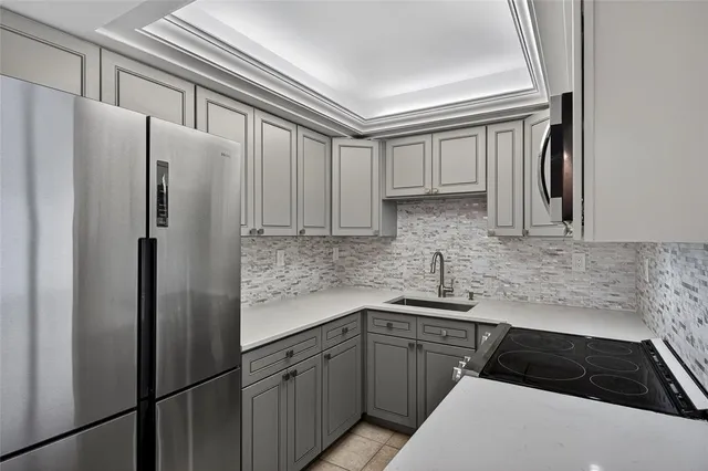 a kitchen with a refrigerator and a sink