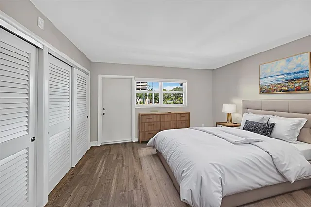 a bedroom with a large bed and a window