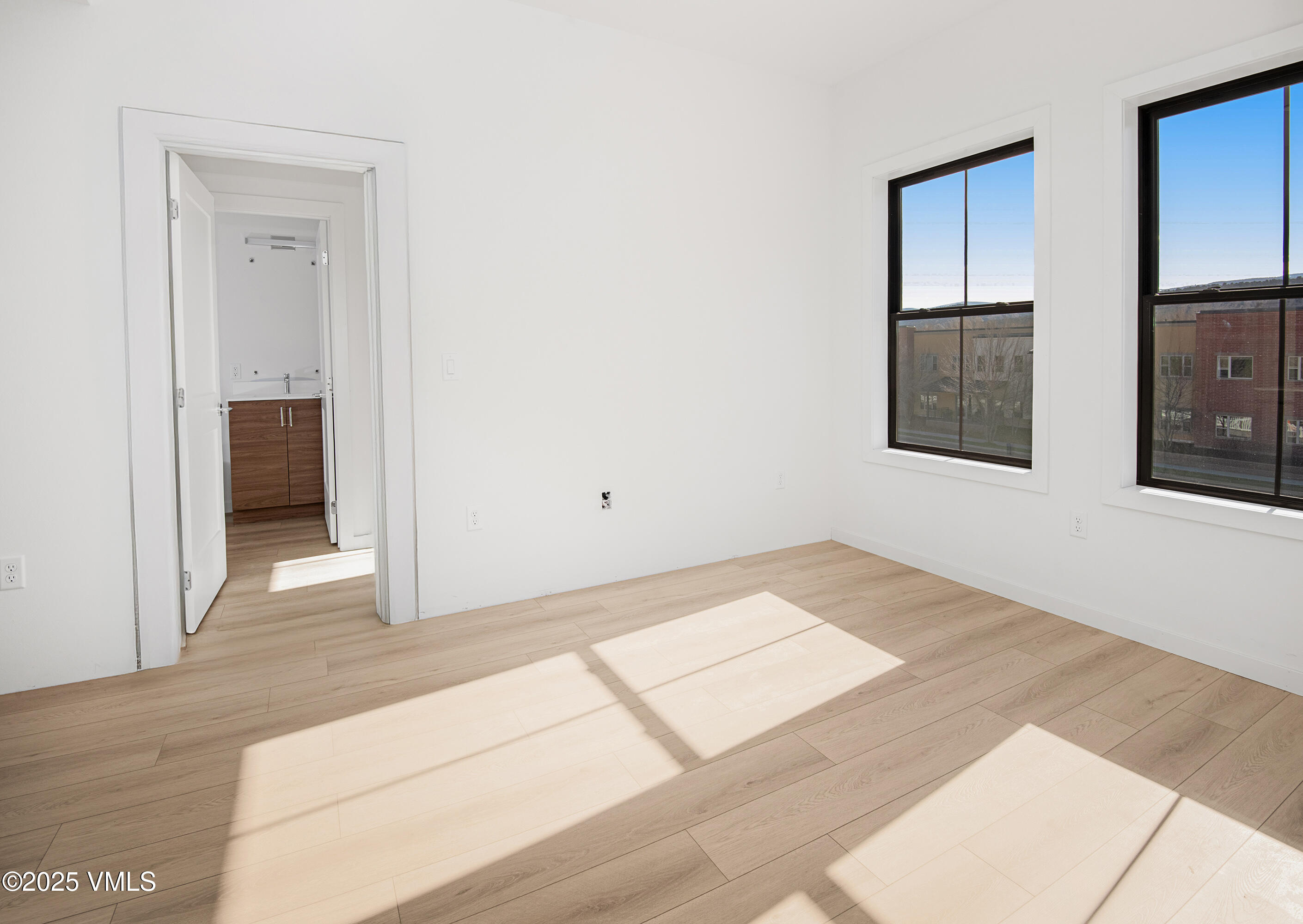 1200 Capitol Street, Unit 101 Eagle, CO 81631 - Photo 19 of 33 a view of an empty room with wooden floor and entryway