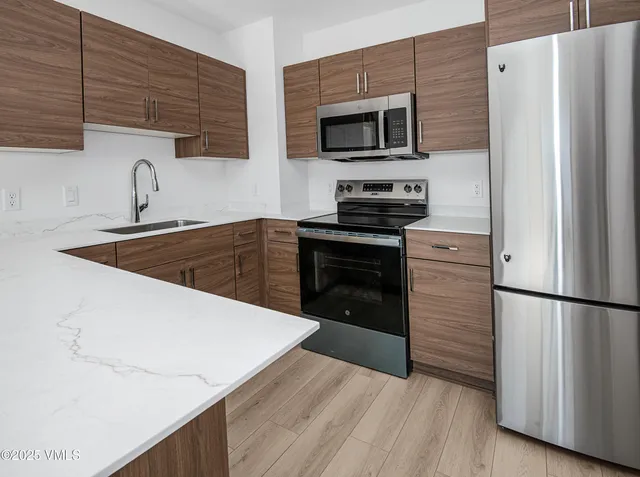 a kitchen with a refrigerator stove and microwave