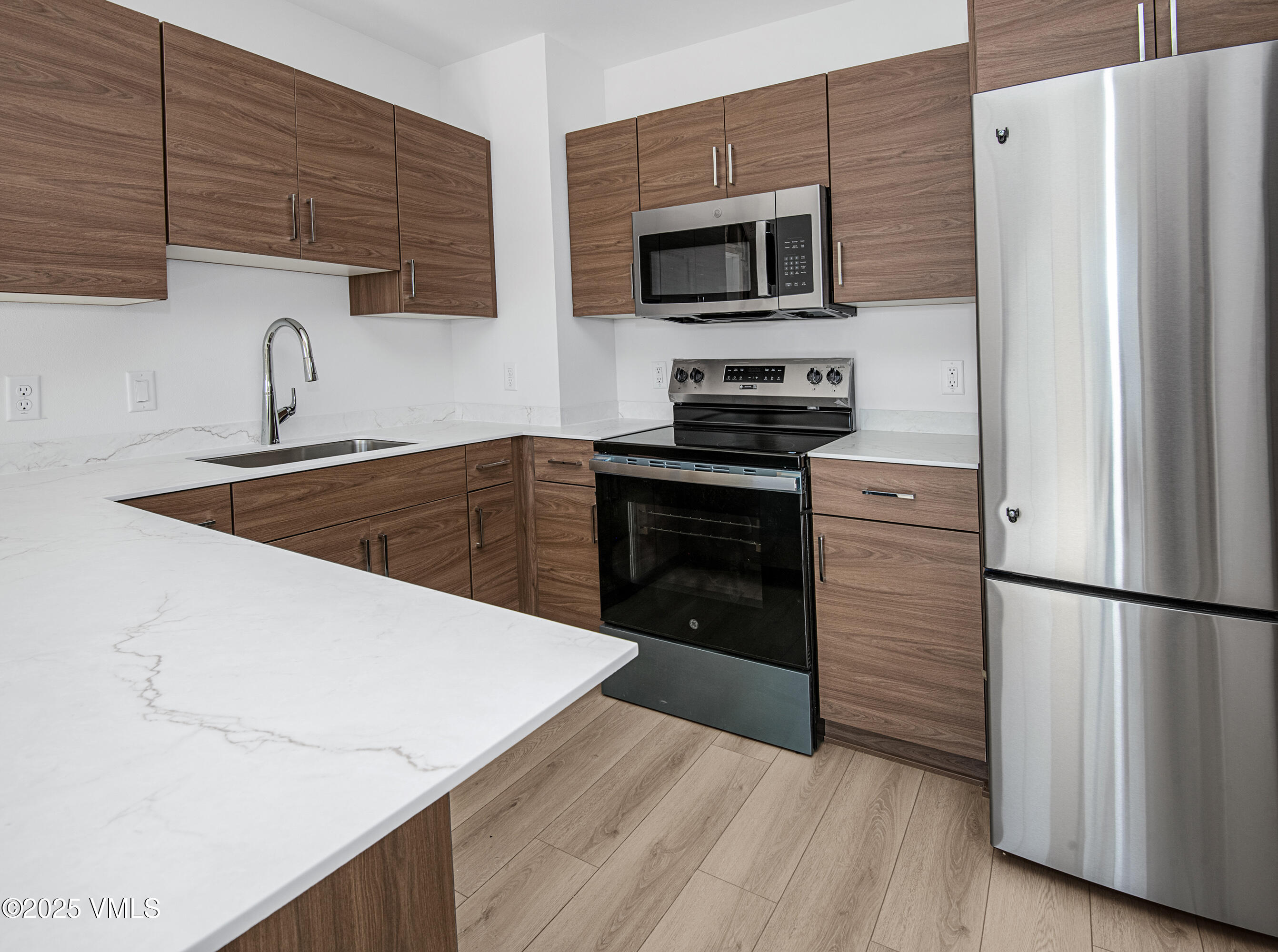 1200 Capitol Street, Unit 101 Eagle, CO 81631 - Photo 2 of 33 a kitchen with a refrigerator stove and microwave