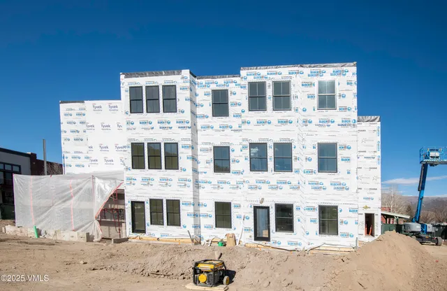 a front view of a building with parking space
