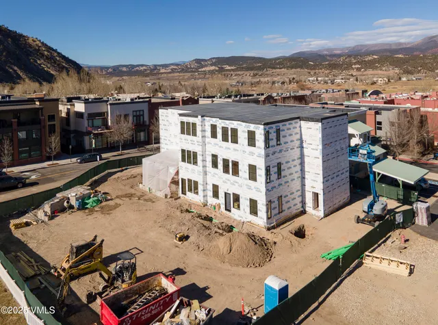 an aerial view of residential houses with outdoor space