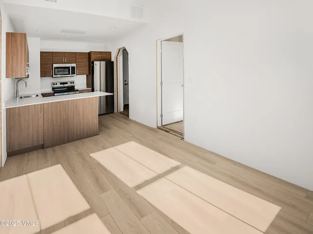 a kitchen with a refrigerator stove and microwave