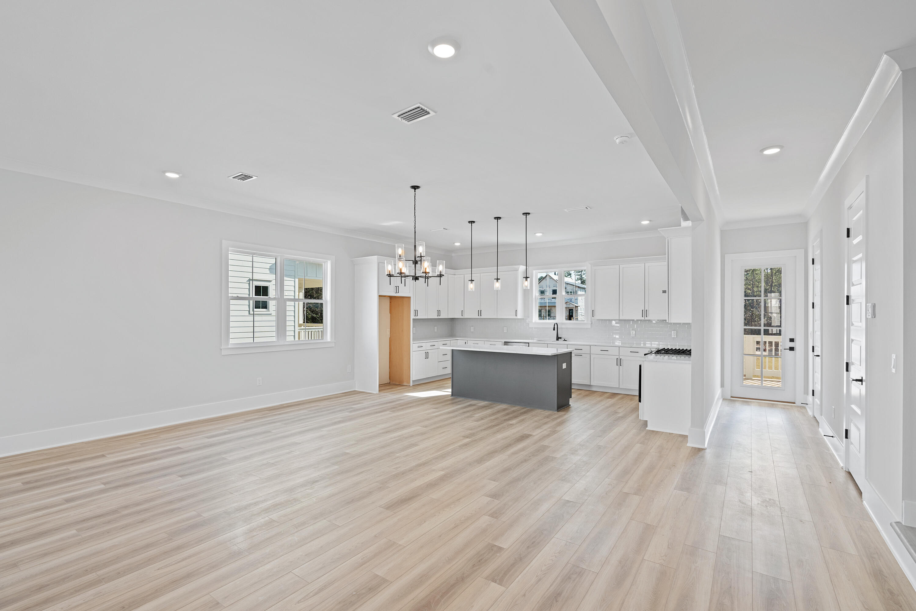 40 Mckenna Way Santa Rosa Beach, FL 32459 - Photo 20 of 61 a large white kitchen with a sink dishwasher a refrigerator and cabinets with wooden floor