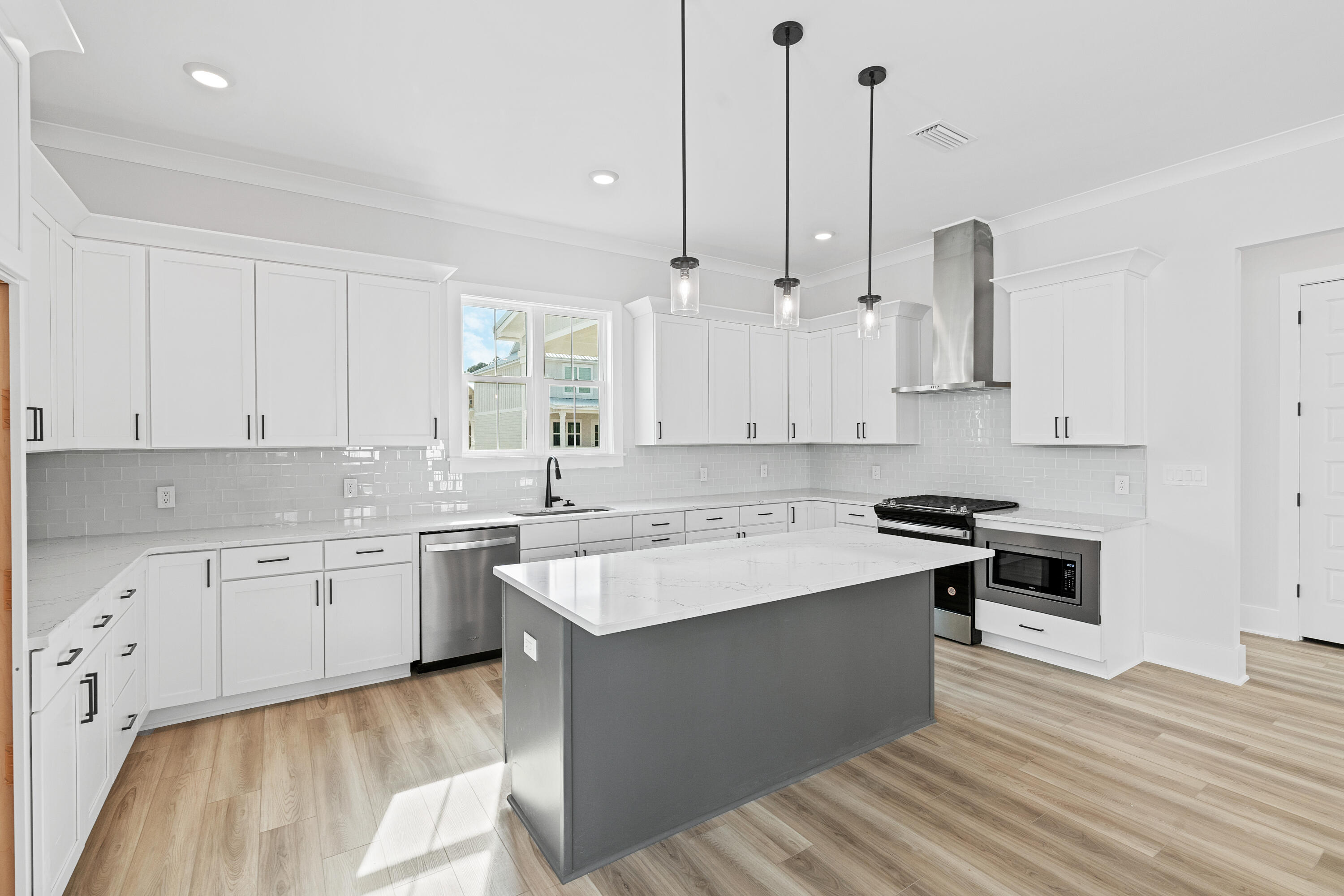 40 Mckenna Way Santa Rosa Beach, FL 32459 - Photo 25 of 61 a large kitchen with stainless steel appliances granite countertop a stove a sink dishwasher and a oven with white cabinets