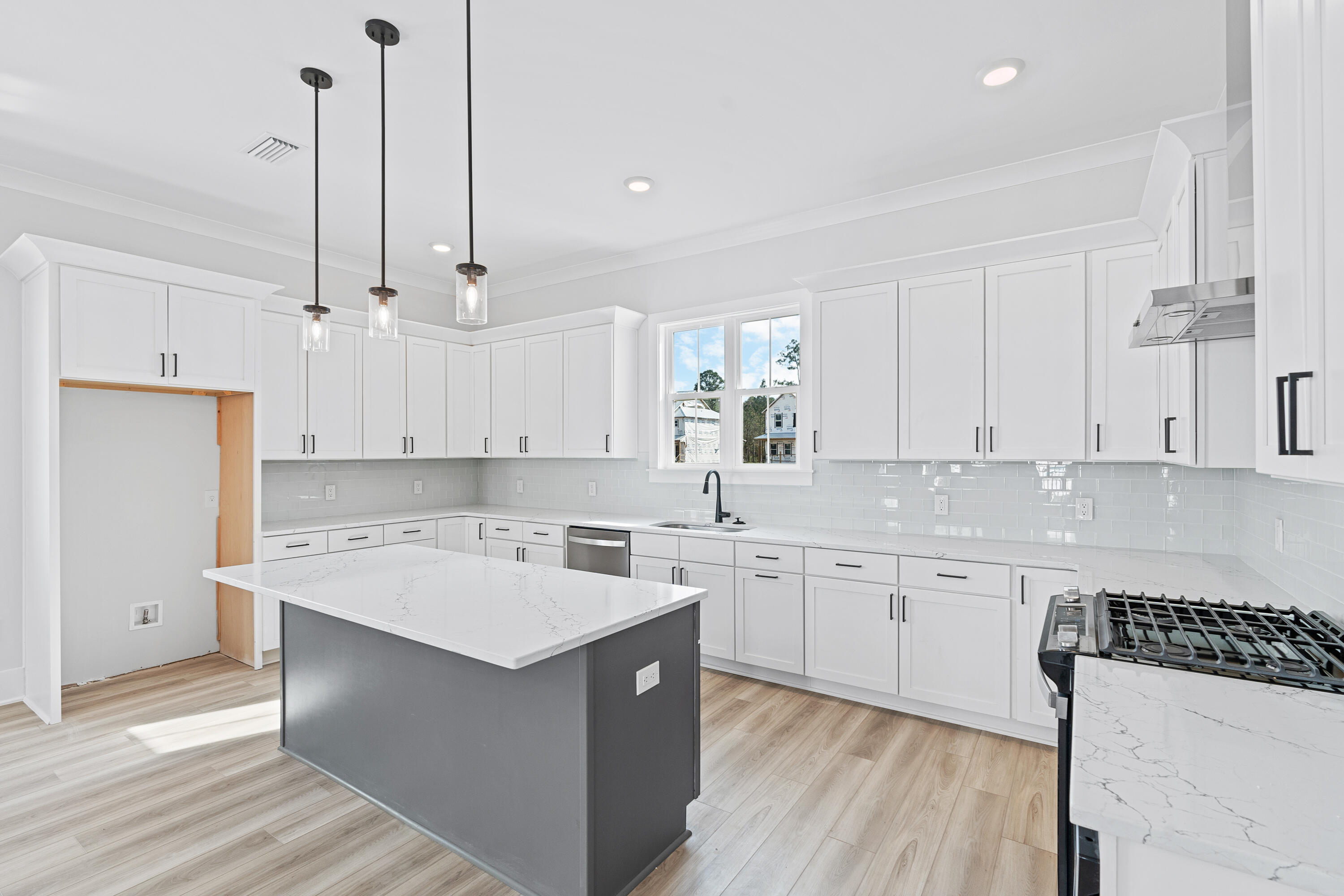 40 Mckenna Way Santa Rosa Beach, FL 32459 - Photo 30 of 61 a kitchen with a sink a stove a refrigerator and white cabinets